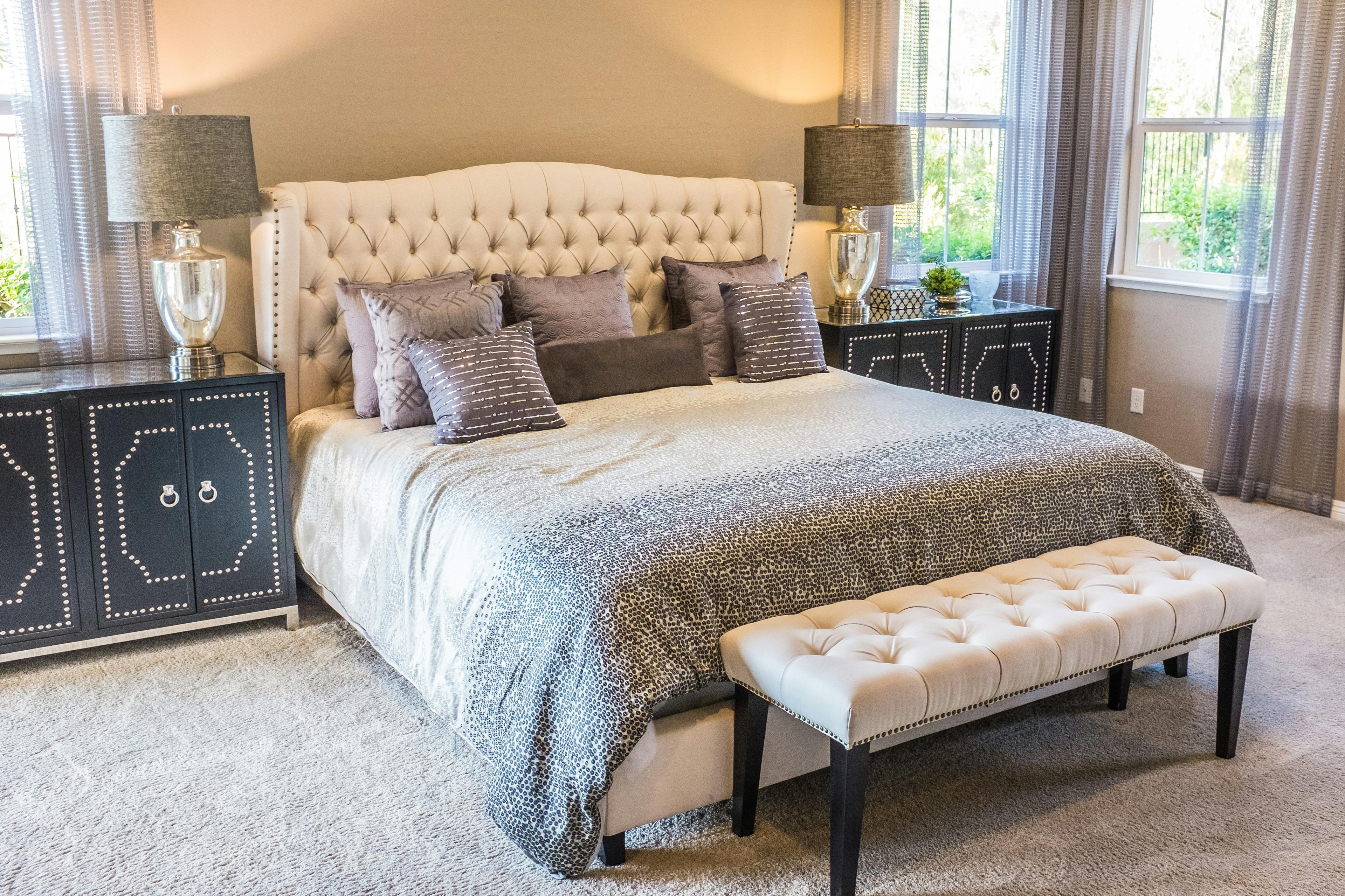 Immaculately cleaned bedroom with the bed freshly made and floors vacuumed